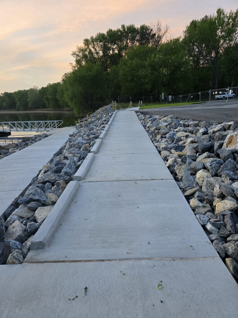 3. ABAAS Accessible Sidewalk Four Locks Boat Ramp Improvements 🚶‍♂️
Accessibility was not an afterthought in these Four Locks Boat Ramp Improvements. The construction of a concrete sidewalk meeting the Architectural Barriers Act Accessibility Standards (ABAAS) is a massive step forward. This path creates a firm, stable, and level connection from the parking lot directly to the floating dock system. ♿

For families with strollers or individuals using mobility aids, this is one of the most impactful Four Locks Boat Ramp Improvements. It ensures that Potomac River Boating Maryland is an inclusive activity that everyone can enjoy regardless of physical ability.