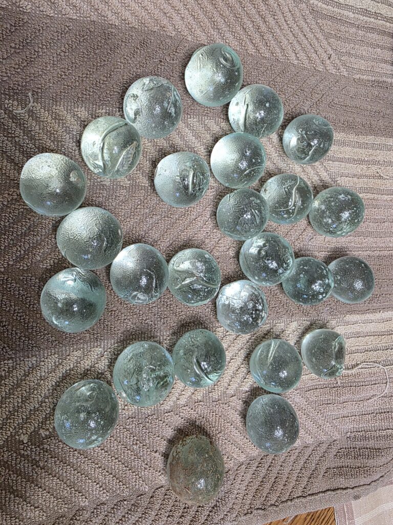 Collection of historic railroad marbles discovered near the railroad corridor at Timber Valley Retreat in Clear Spring, Maryland.