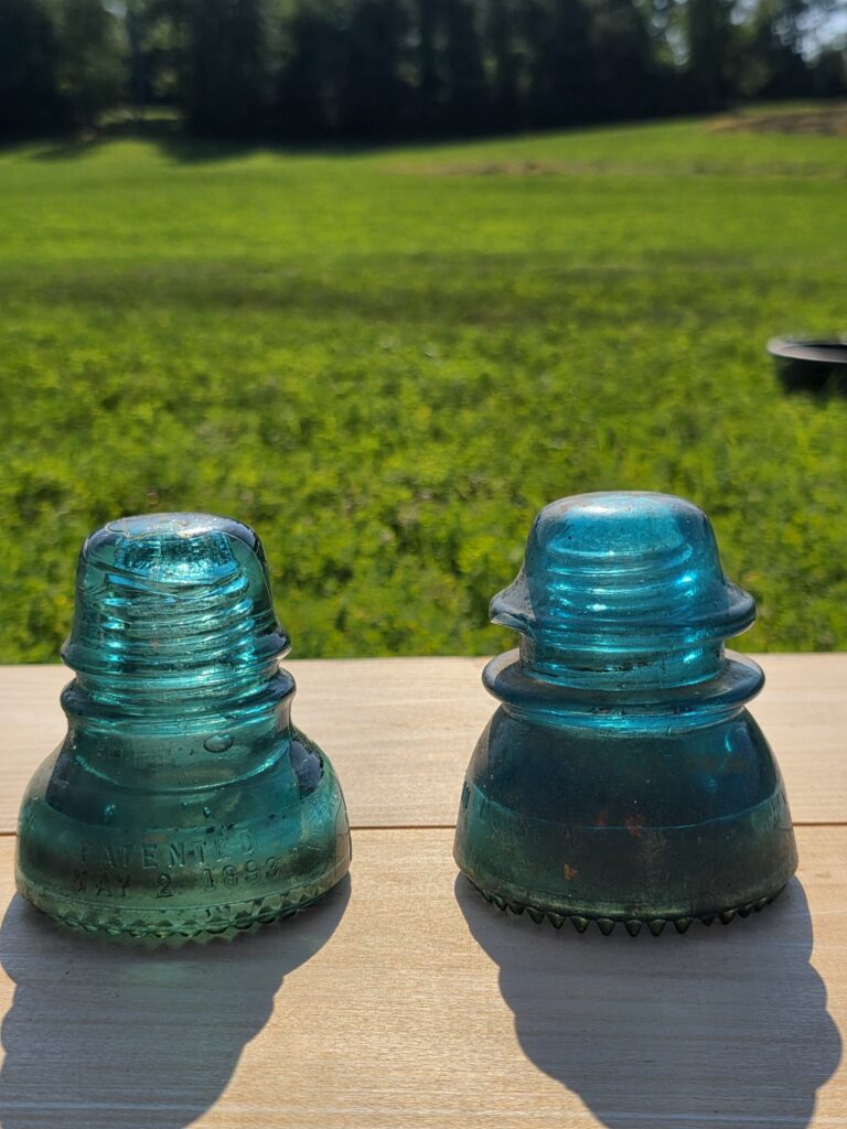 Vintage railroad artifacts like glass insulators collected by Tom and Karen at Timber Valley Retreat, highlighting Train Watching Maryland and unique Things to Do in Maryland.