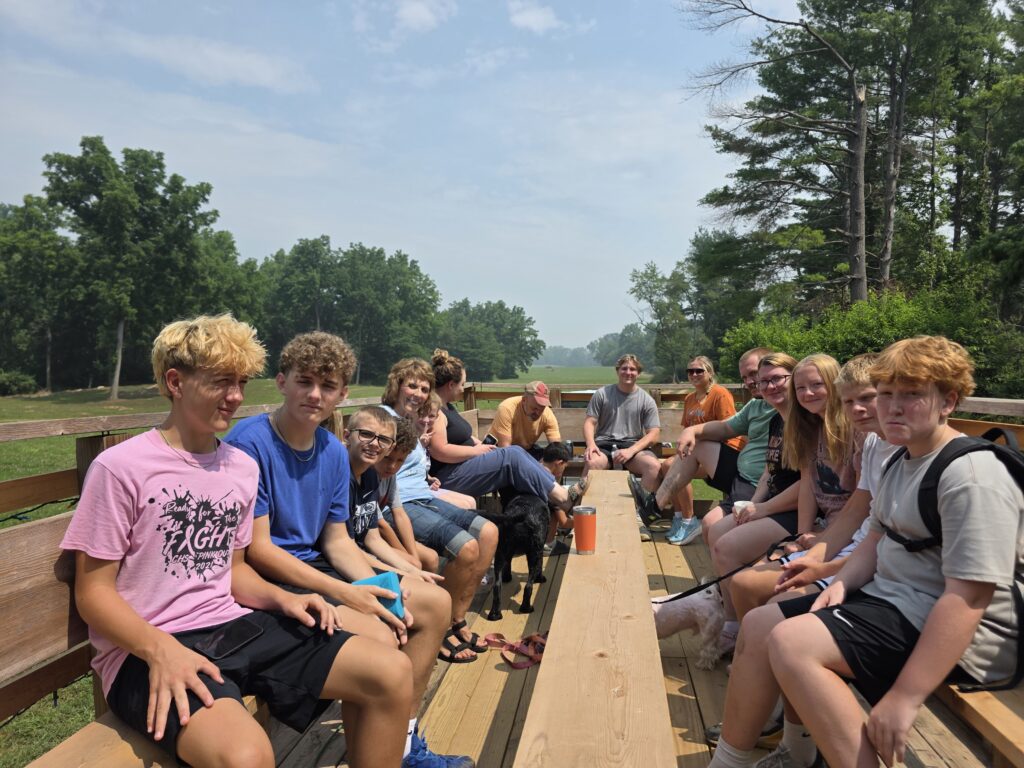 Guests enjoying a Family Wagon Ride in Western Maryland aboard the Timber Valley Trailblazer at Timber Valley Retreat, surrounded by beautiful countryside and unforgettable family memories.