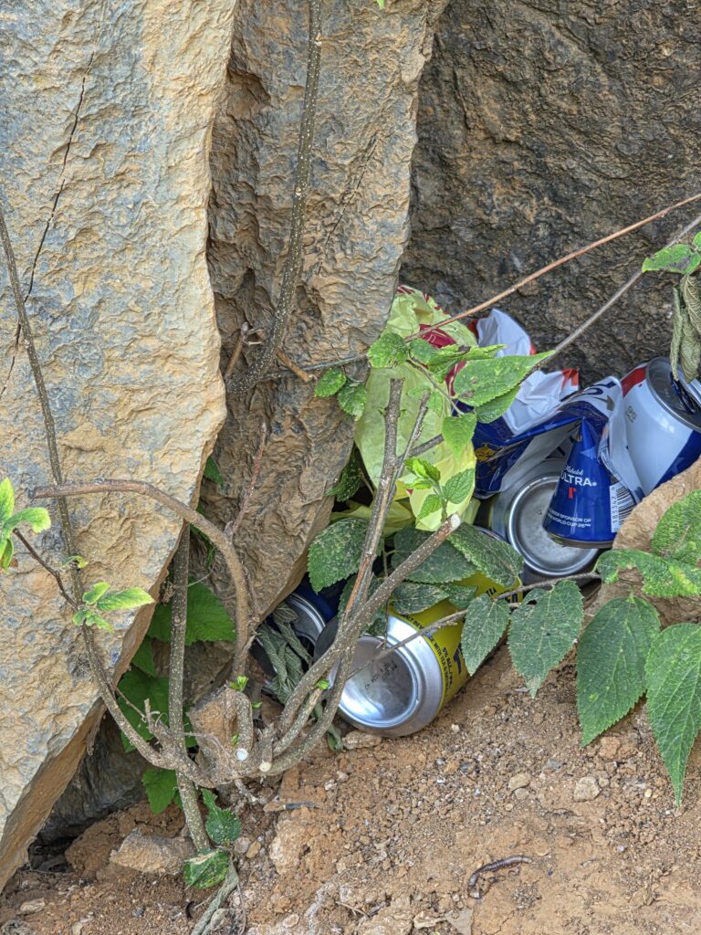 Trash hidden among the rocks at Rock Cliff above Dam #5 serves as a reminder that practicing Leave No Trace includes leaving natural places cleaner than you found them.