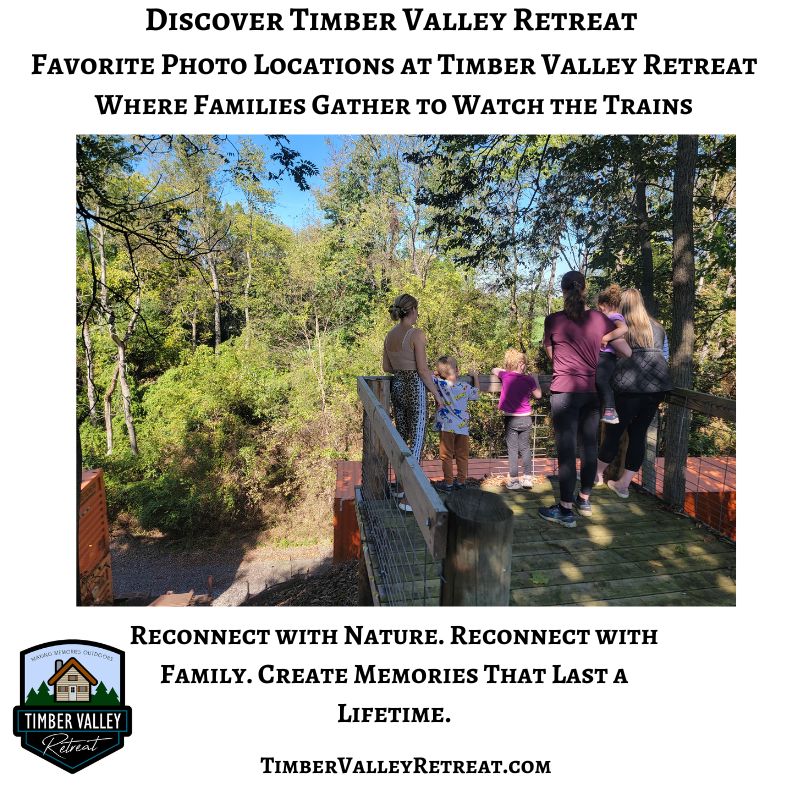 A family watches a passing train from the Timber Valley Railroad Overlook at Timber Valley Retreat, enjoying one of the scenic highlights of this Western Maryland cabin retreat.