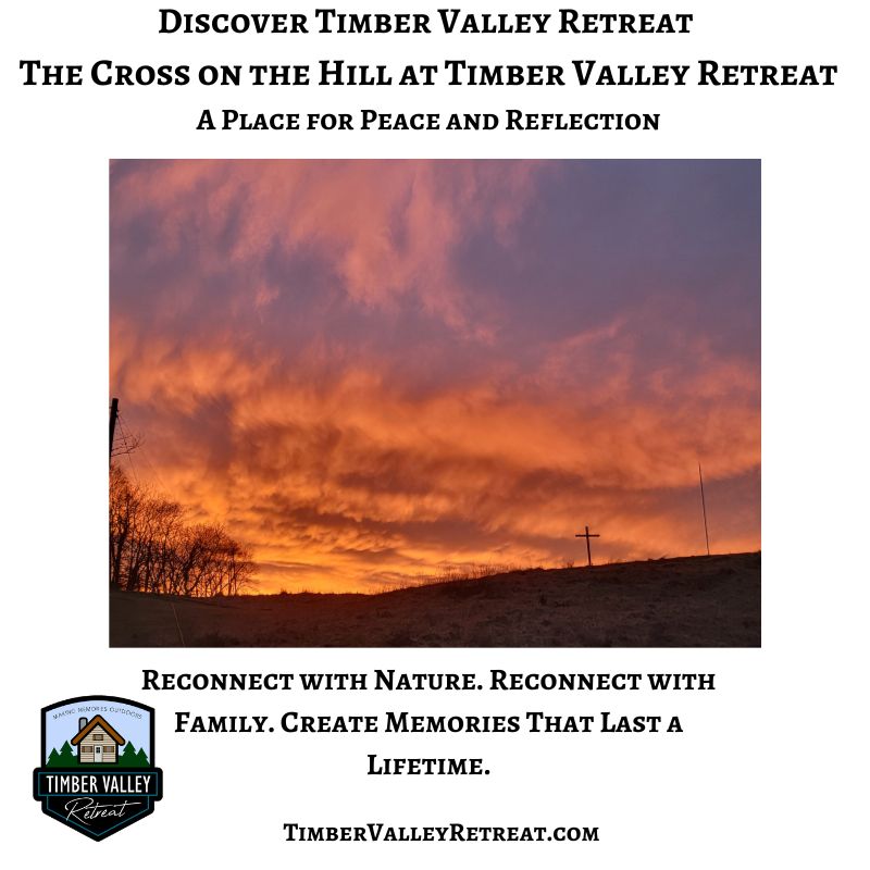 A wooden cross silhouetted against a brilliant sunset at Timber Valley Retreat in Western Maryland, offering a peaceful place for quiet reflection.