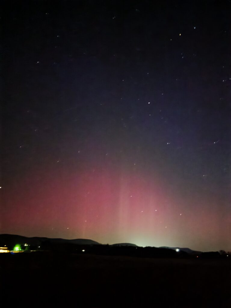 Yes—but only during rare periods of exceptionally strong solar activity.
On a few unforgettable nights, the sky above Timber Valley Retreat has come alive with brilliant shades of pink, purple, and green as the Northern Lights stretched across the northern horizon. Watching this incredible display from our farm was a once-in-a-lifetime experience that reminded us just how amazing the natural world can be.
Although the Aurora Borealis is not a regular occurrence in Maryland, powerful geomagnetic storms can occasionally make the Northern Lights visible much farther south than usual. We were fortunate enough to capture these remarkable moments from Timber Valley Retreat, preserving memories of a sky that few people ever expect to see in our region.
While we can't promise the Northern Lights during your visit, we can promise something just as meaningful—a peaceful place to slow down, look toward the heavens, and appreciate the beauty of nature. And if the stars happen to align with another rare aurora, you'll have an unforgettable front-row seat beneath the skies of Timber Valley Retreat.
