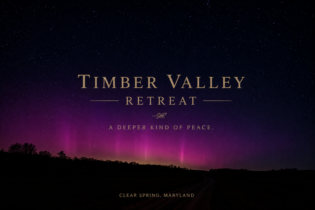 Dark night sky above Timber Valley Retreat in Clear Spring, Maryland, featuring brilliant stars and the northern lights, making it an unforgettable Western Maryland summer vacation destination for stargazing and peaceful cabin getaways.