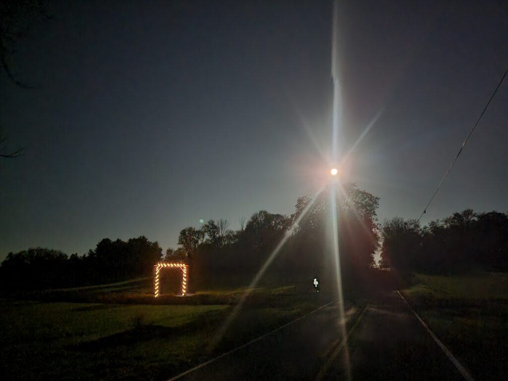 Moonrise over the fields at Timber Valley Retreat with a glowing pathway beneath the nighttime sky