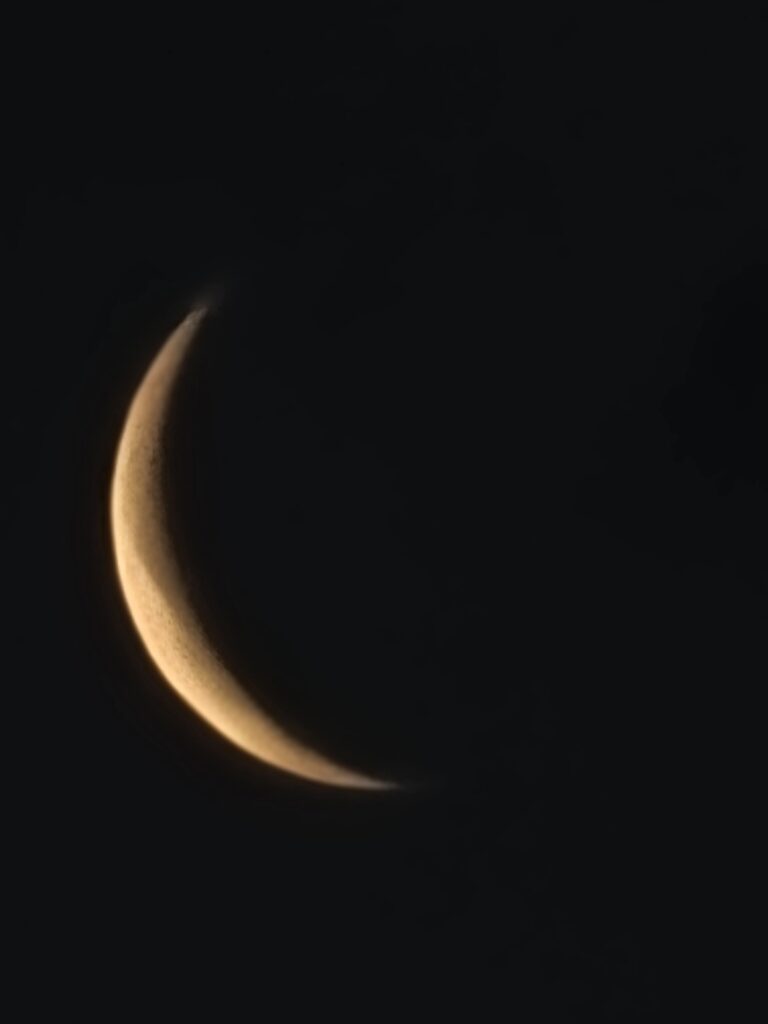 Crescent moon glowing against a dark night sky at Timber Valley Retreat