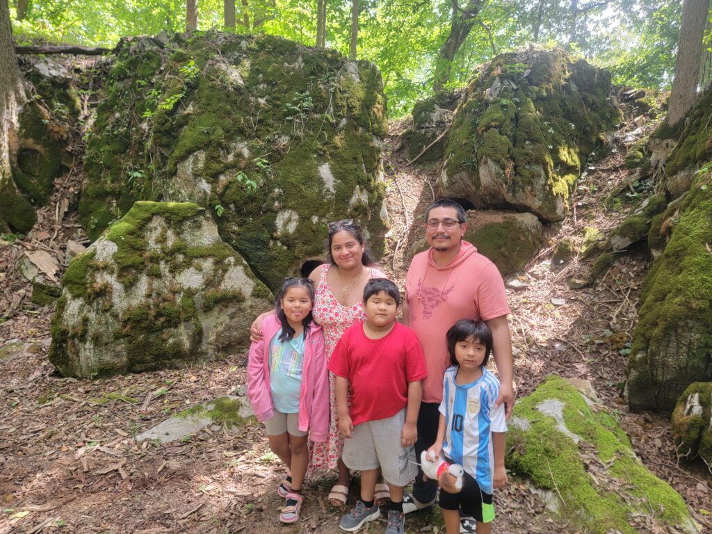 Family Reconnecting Families in Nature among moss-covered boulders and woodland trails at Timber Valley Retreat in Clear Spring, Maryland.