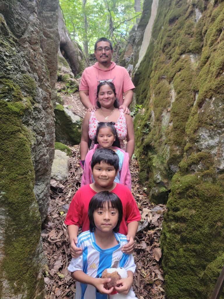 Family exploring the moss-covered boulders in The Enchanted Forest at Timber Valley Retreat during a Woodland Wellness Getaway Maryland in Western Maryland.
