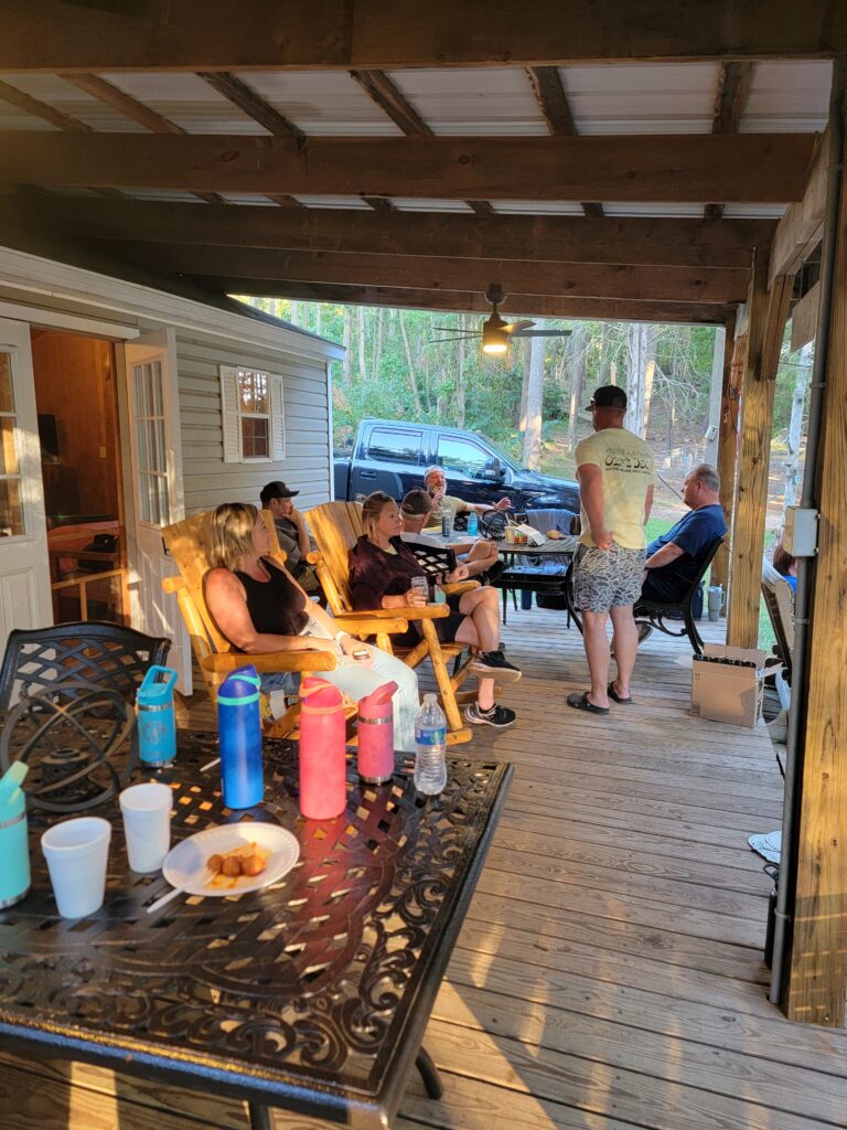 Families enjoying a Family Cabin Vacation Maryland while relaxing together on the porch during a Large Family Cabin Getaway at Timber Valley Retreat.