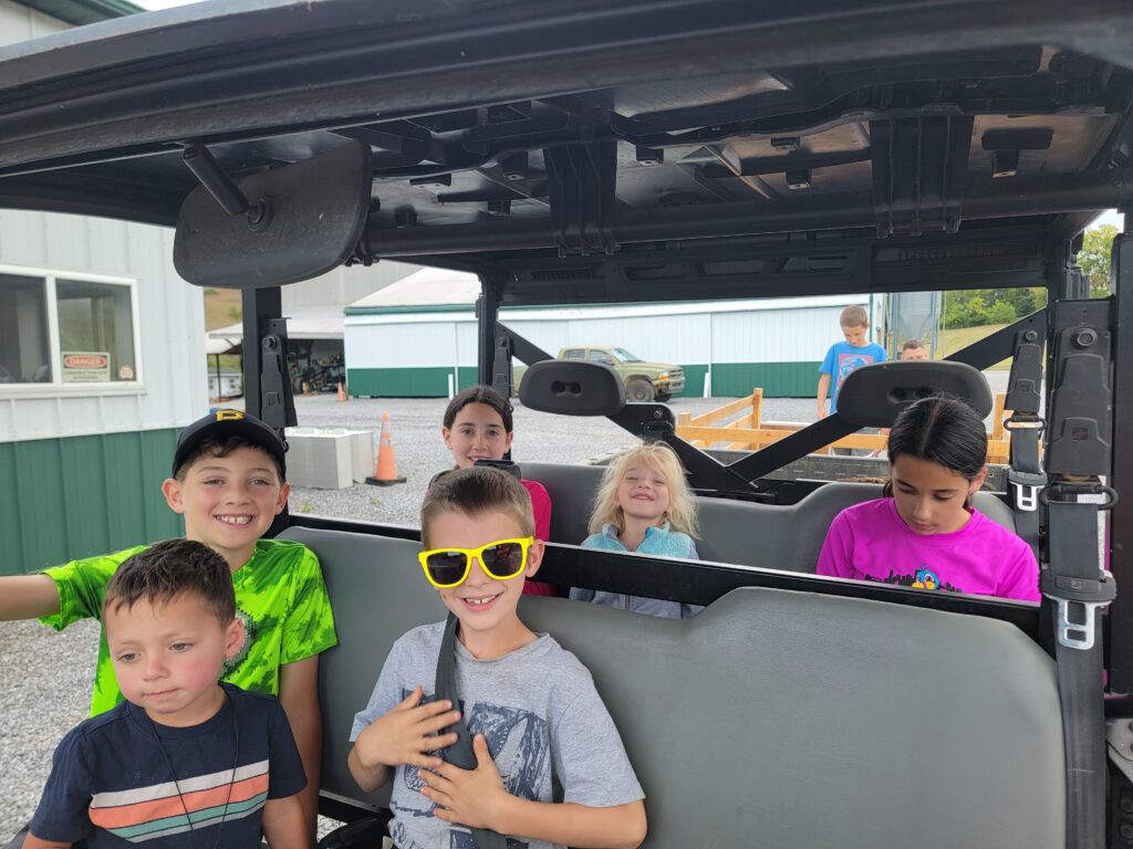 Children enjoying a ride together aboard the Timber Valley Trailblazer at Timber Valley Retreat in Clear Spring Maryland.