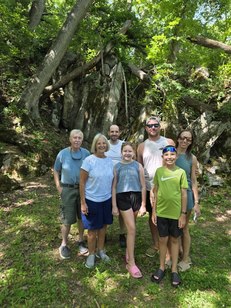 Three generations enjoying a Family Cabin Vacation Maryland while exploring The Enchanted Forest at Timber Valley Retreat.
