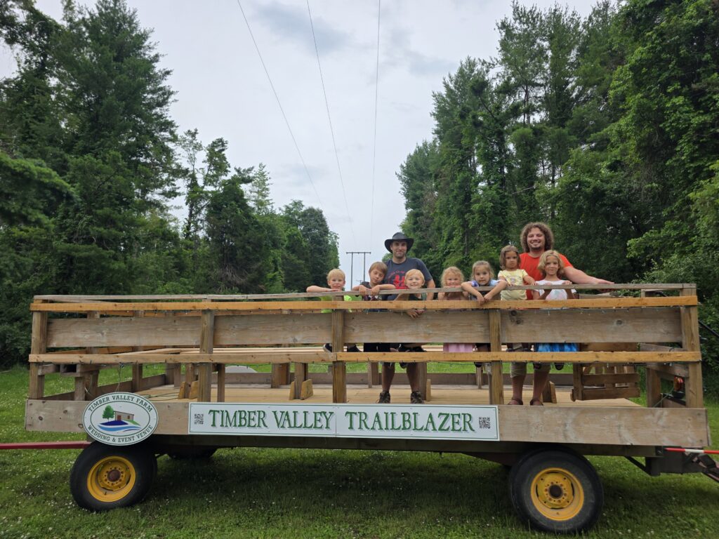 Family group enjoying a ride together aboard the Timber Valley Trailblazer at Timber Valley Retreat in Clear Spring, Maryland.