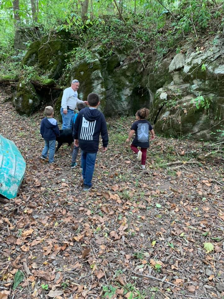 Children exploring moss-covered rocks and woodland trails with Tom at Timber Valley Retreat during a Family Nature Escape Western Maryland.