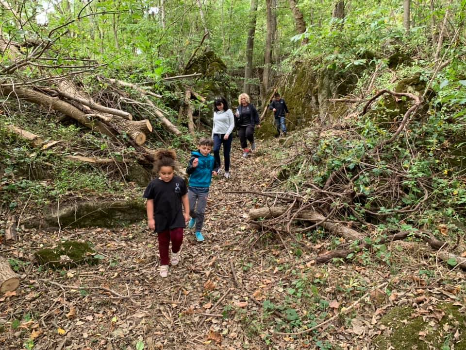 Family walking together through the wooded trails at Timber Valley Retreat during a Digital Detox Family Getaway Maryland.