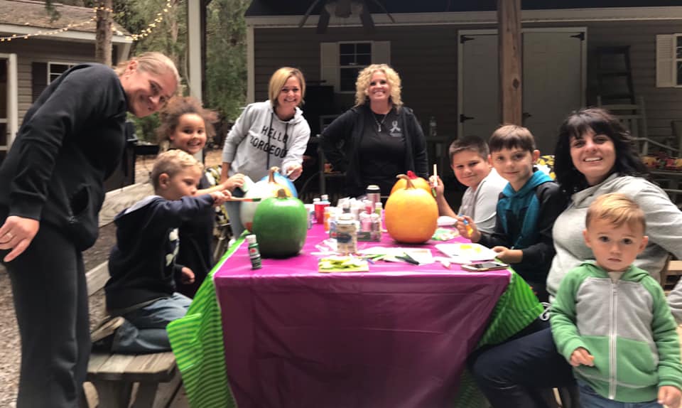 Family gathered together for a creative activity at Timber Valley Retreat during a Screen Free Family Vacation Maryland.