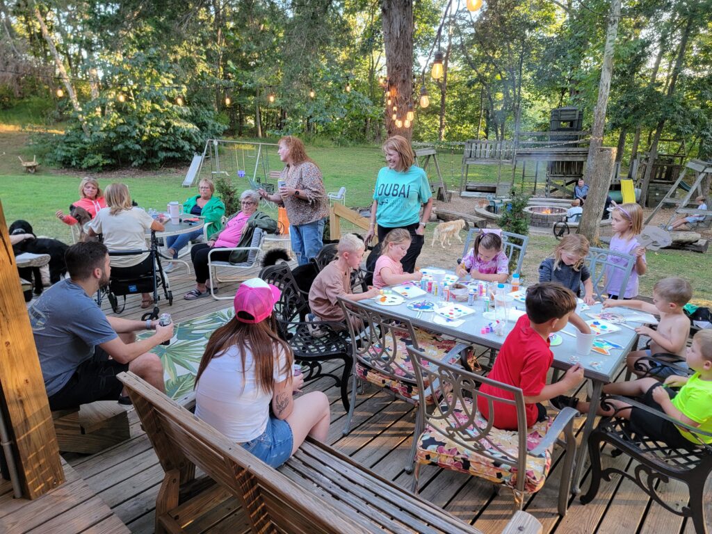 Families enjoying Multi-Generational Family Vacations together outside the cabins at Timber Valley Retreat during a Family Getaway Western Maryland.