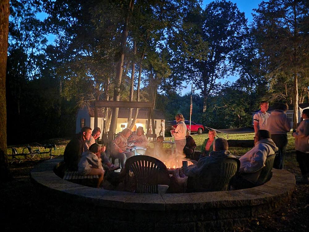 Guests relaxing around the campfire at Timber Valley Retreat, a peaceful place in Maryland and an Exclusive Private Cabin Retreat near Washington DC, Northern Virginia, Pennsylvania, West Virginia, and Maryland's Eastern Shore.