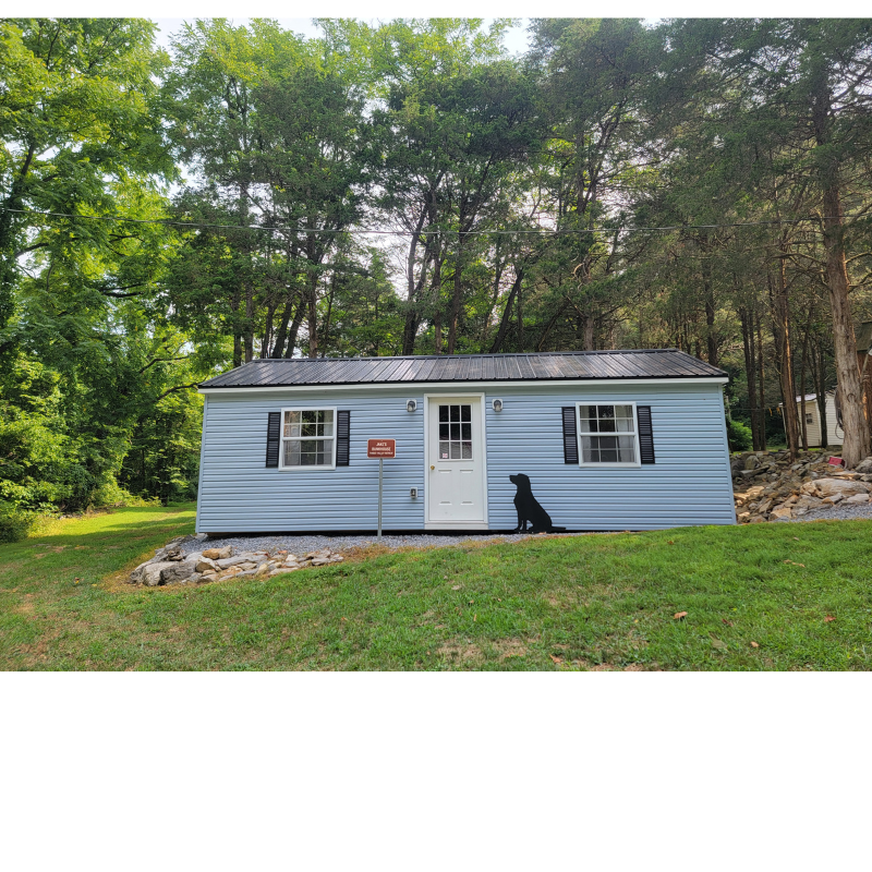 Jake's Bunkhouse cabin at Timber Valley Retreat surrounded by trees in Western Maryland