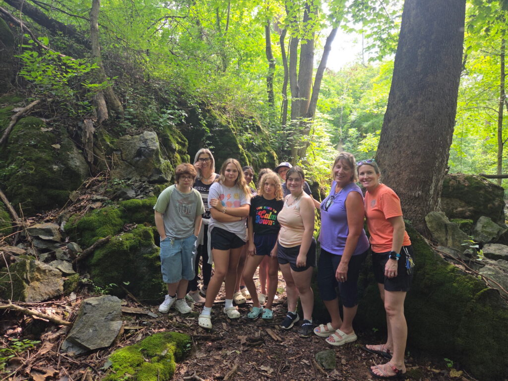 Girl Scouts enjoying a group cabin getaway in Maryland while exploring the woodland setting at Timber Valley Retreat