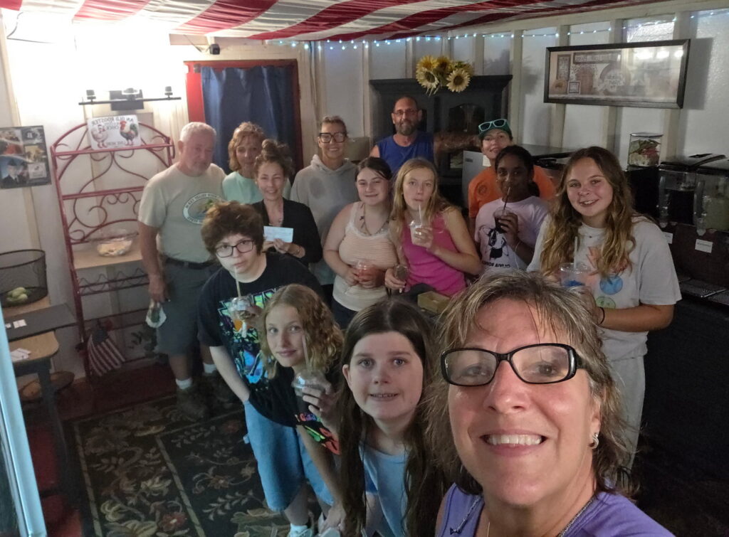 Girl Scouts enjoying a group cabin getaway in Maryland and supporting a local farmstand during their Timber Valley Trailblazer wagon ride