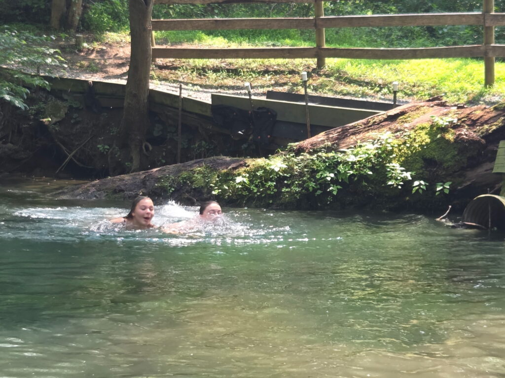 Girl Scouts enjoying a refreshing water activity during a group cabin getaway in Maryland at Timber Valley Retreat