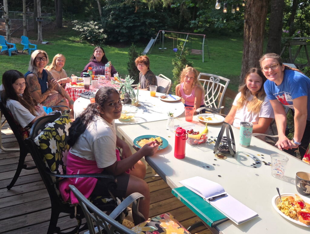 Girl Scouts sharing a meal during a Maryland group cabin getaway at Timber Valley Retreat