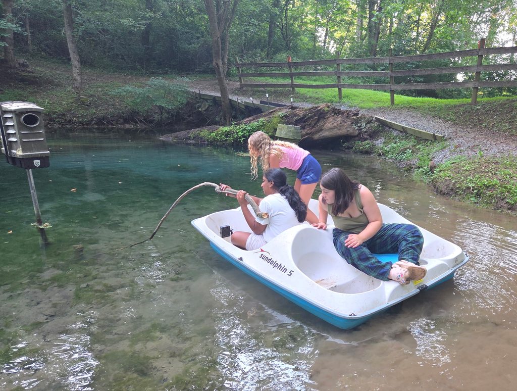 Group Camping Near Me with youth group exploring the spring-fed pond at Timber Valley Retreat