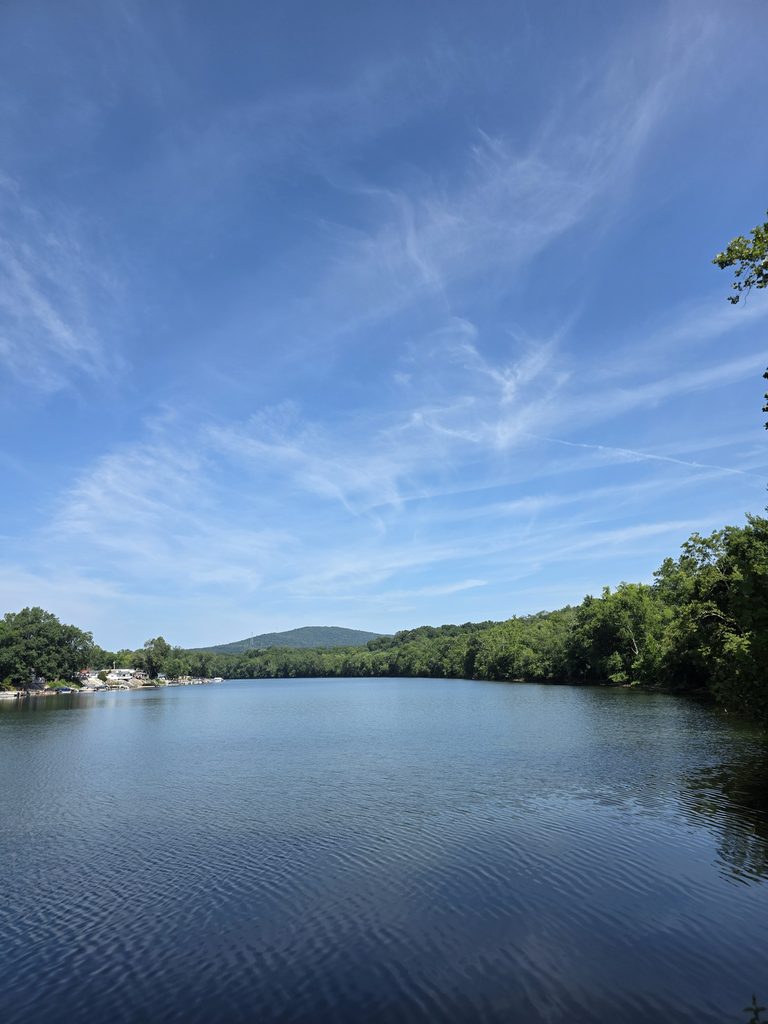 Peaceful woodland shoreline and blue water near Timber Valley Retreat in Clear Spring, Maryland